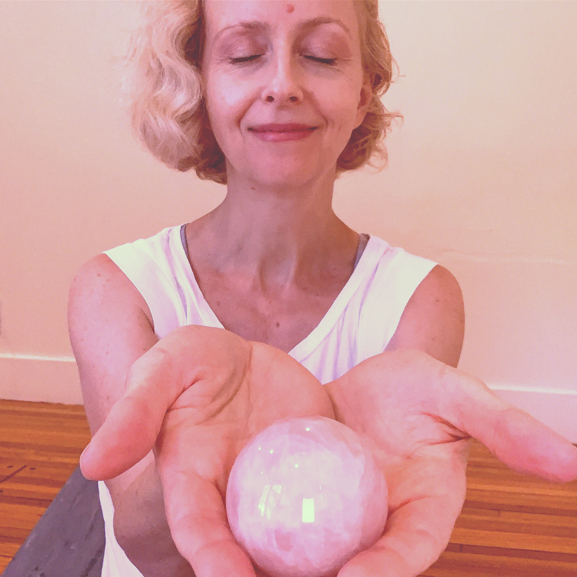 Woman offering rose quartz ball